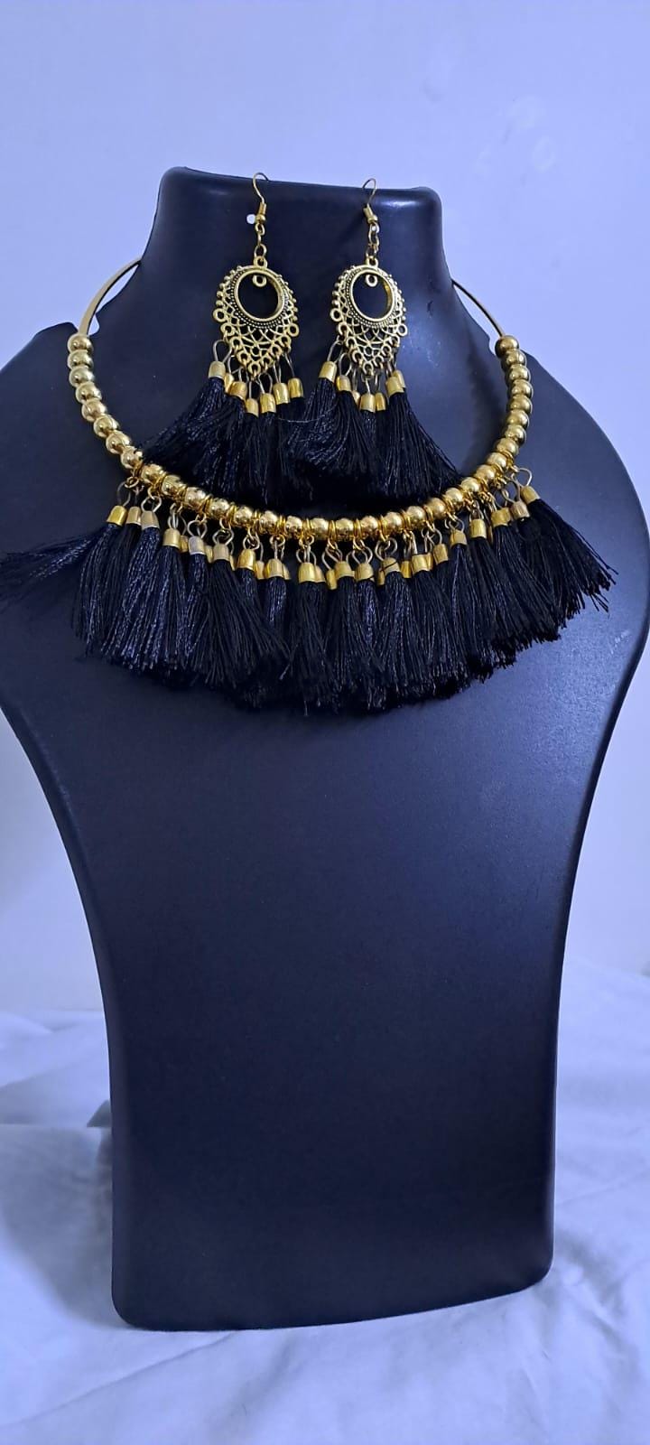 Golden neckband with black silk thread fringes and matching earrings