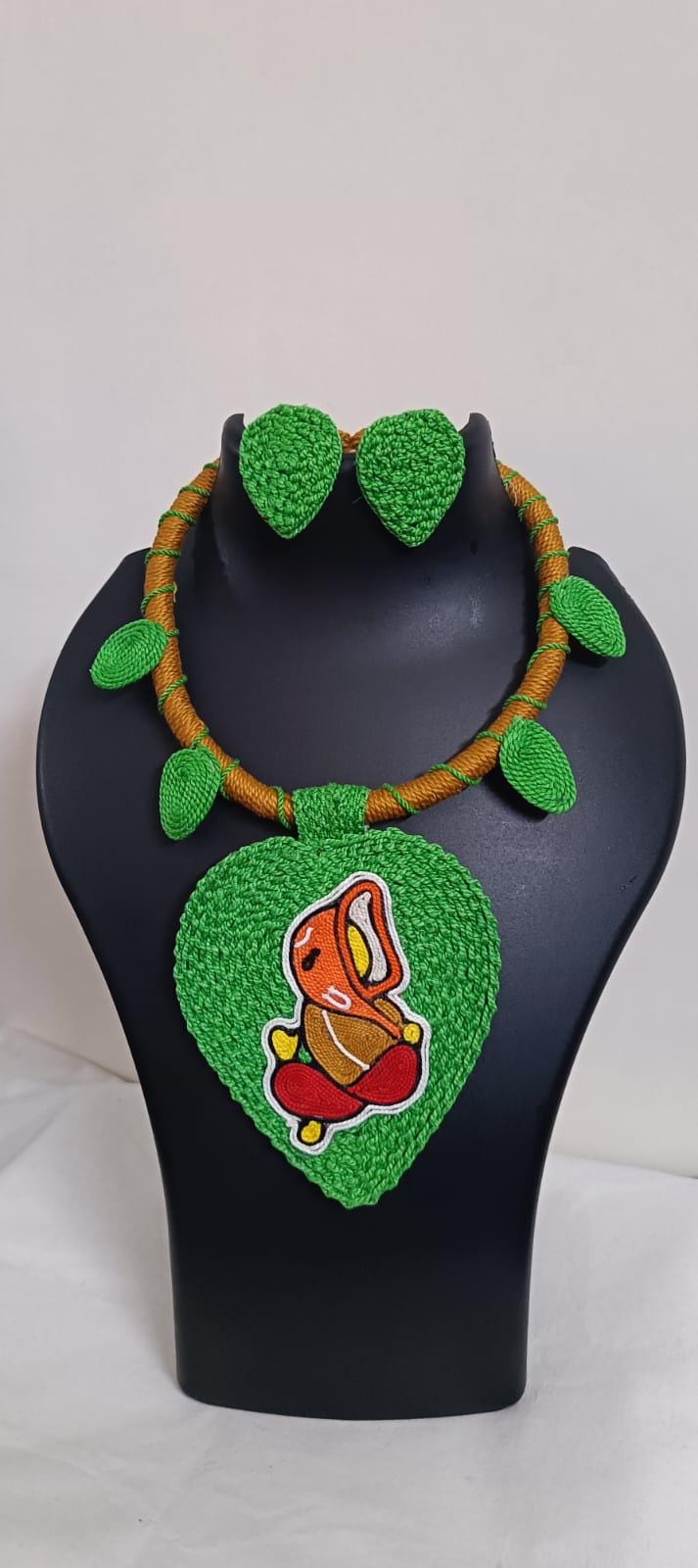 Exclusive light green and brown  thread necklace with leaf shaped  Ganesha pendant  and matching earrings.