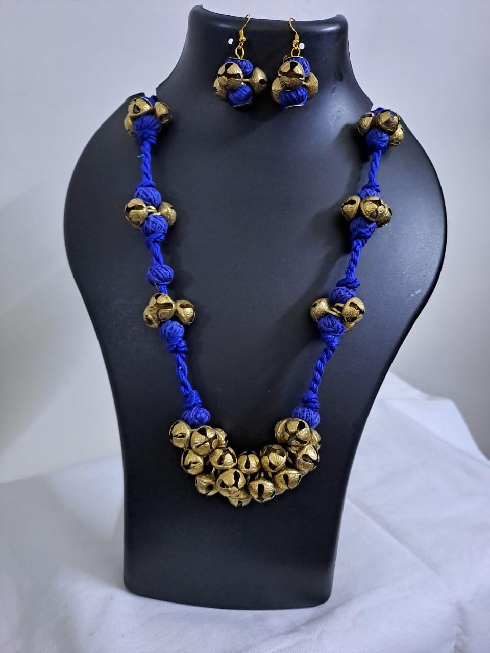 Blue thread necklace with trinkets n matching earrings