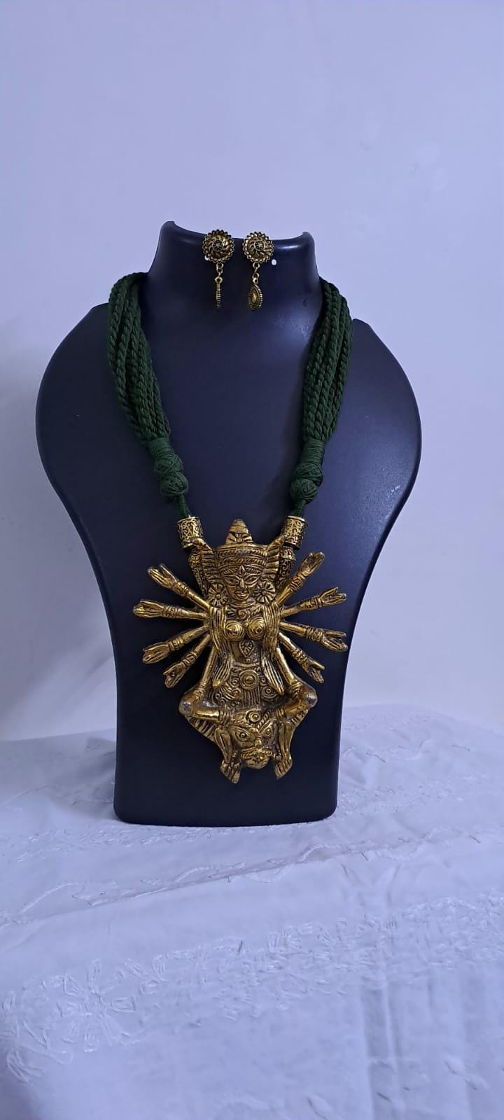 Green thread necklace with oxidised golden durga pendant