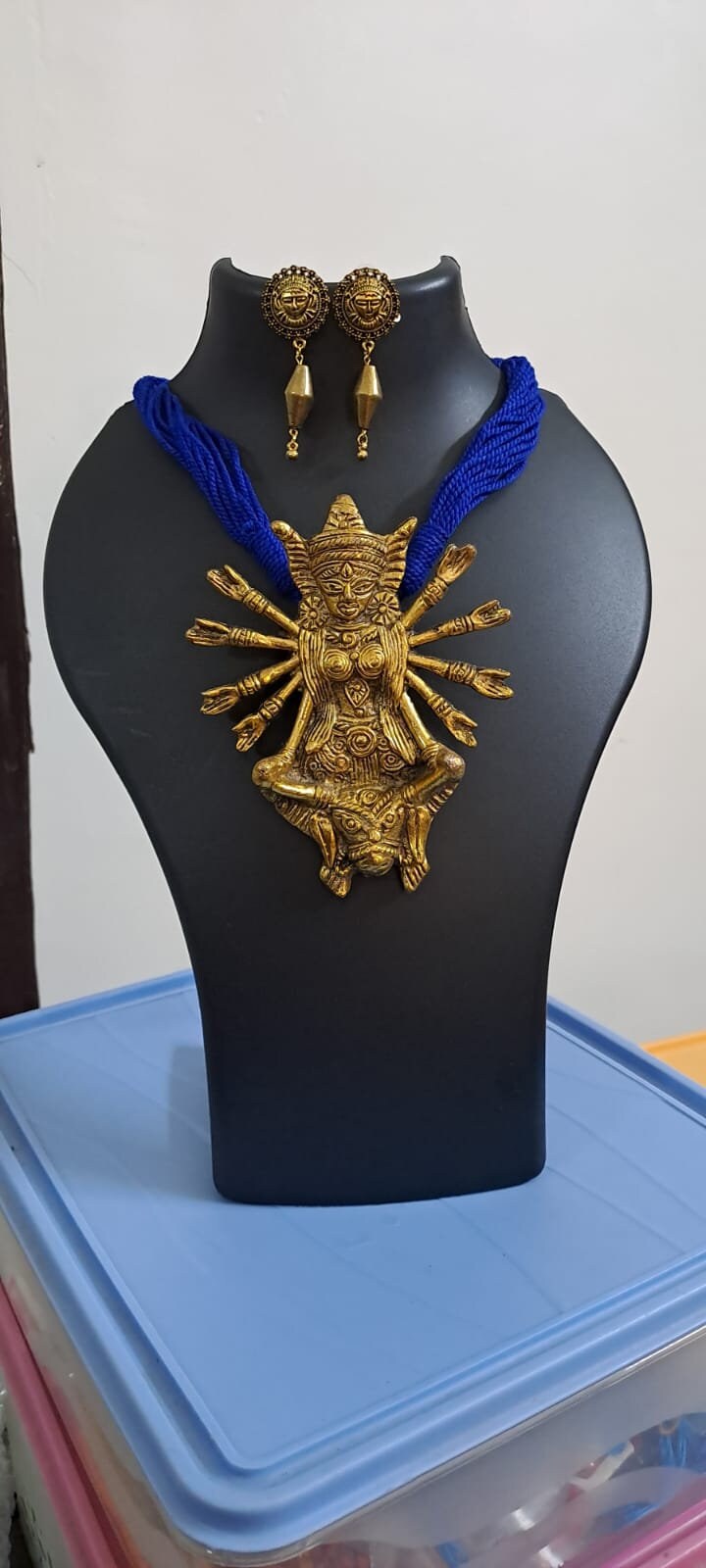 Blue thread necklace with oxidised golden durga pendant