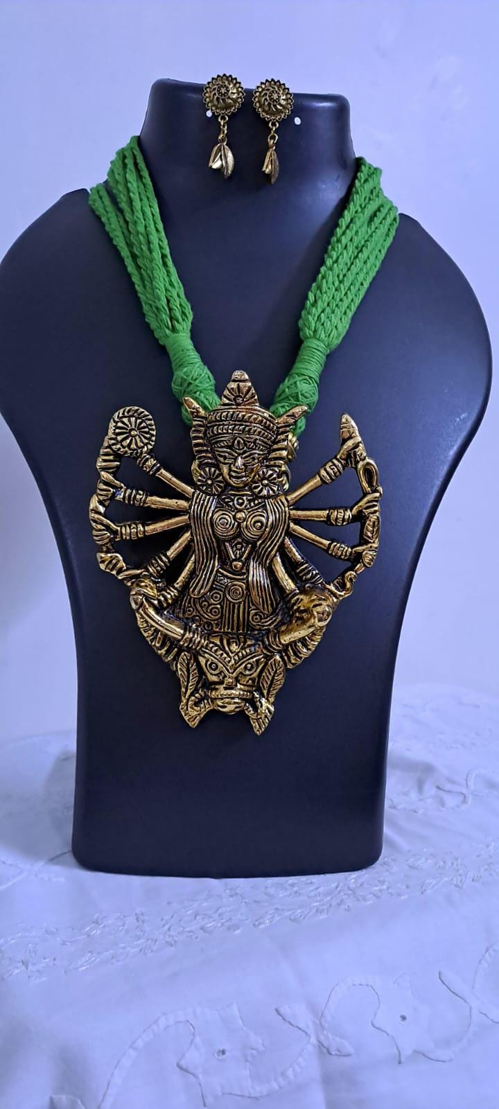 Green thread necklace with oxidised golden durga pendant