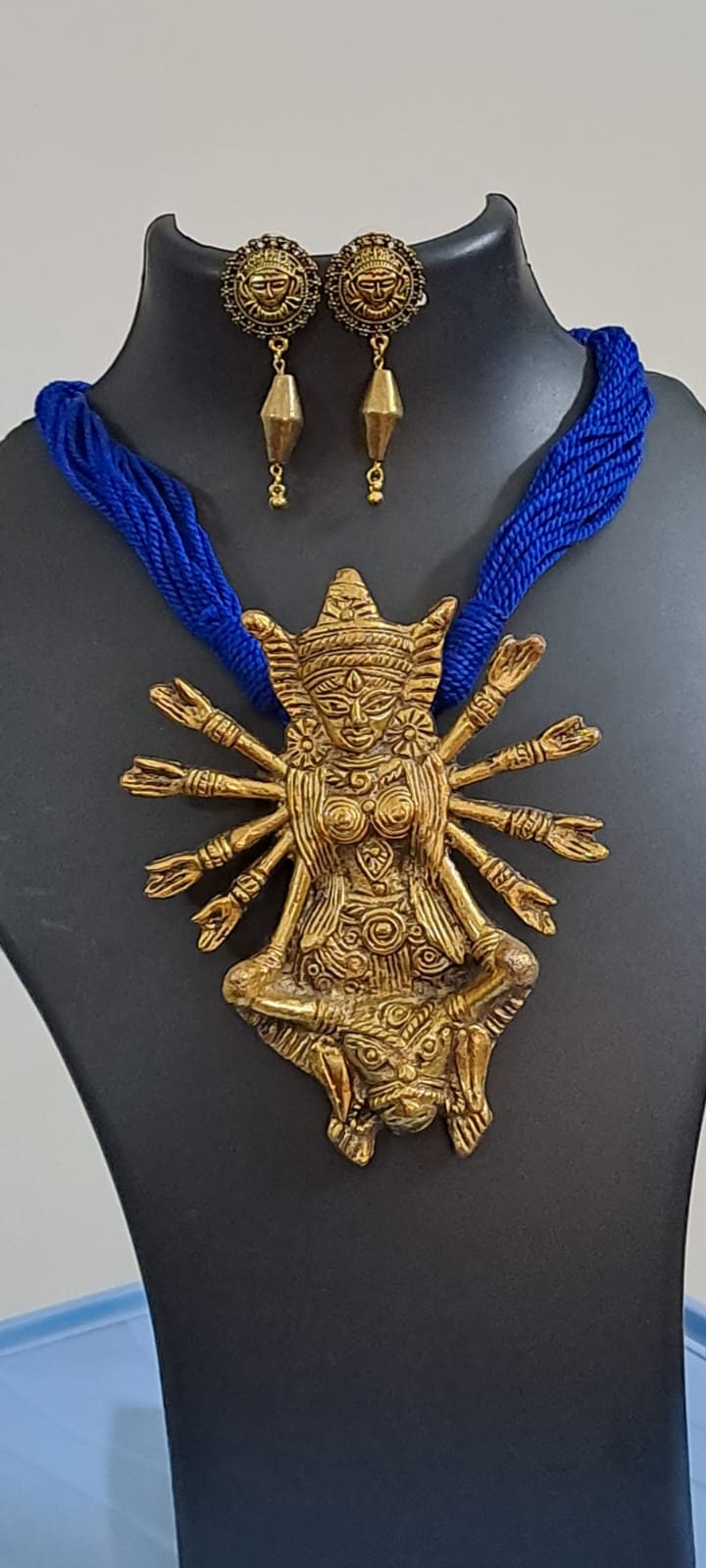 Blue thread necklace with oxidised golden durga pendant