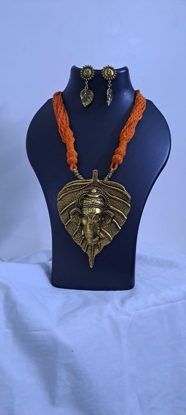 Orange thread necklace with golden oxidised ganesha pendant