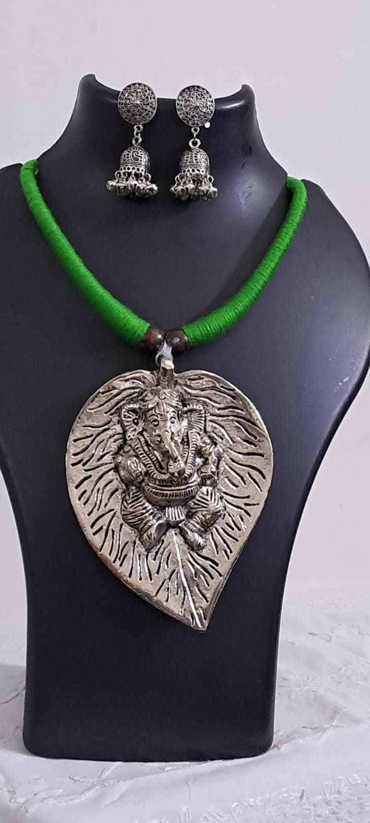 Green thread necklace with silver oxidised ganesha pendant