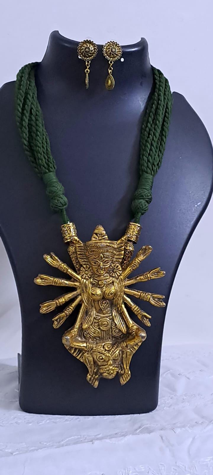 Green thread necklace with oxidised golden durga pendant