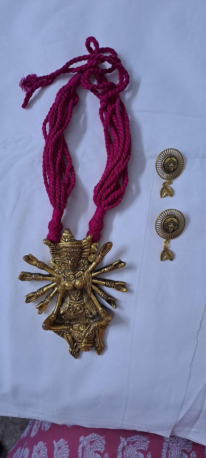 Pink thread necklace with oxidised golden durga pendant