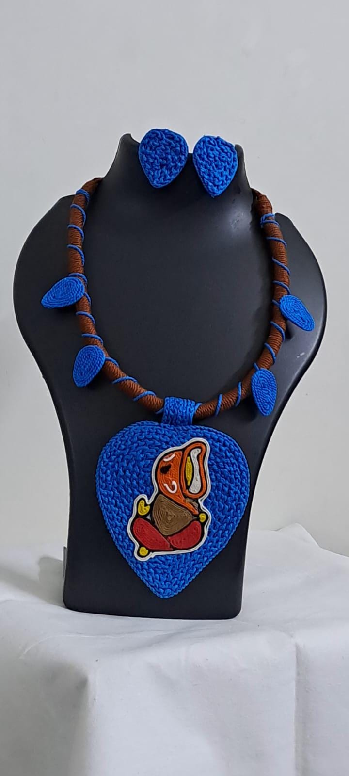 Exclusive brown and blue thread necklace with leaf shaped  Ganesha thread pendant and matching earrings.