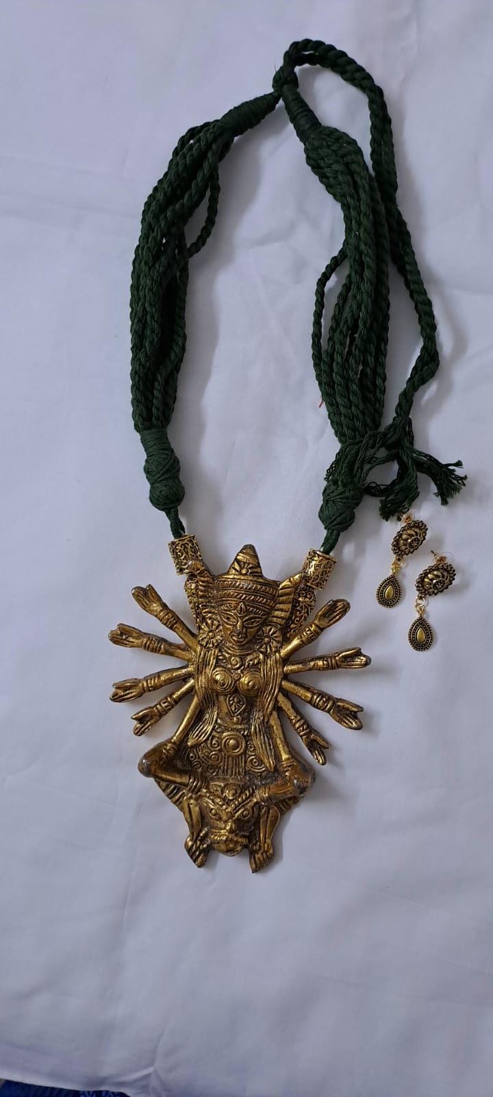Green thread necklace with oxidised golden durga pendant