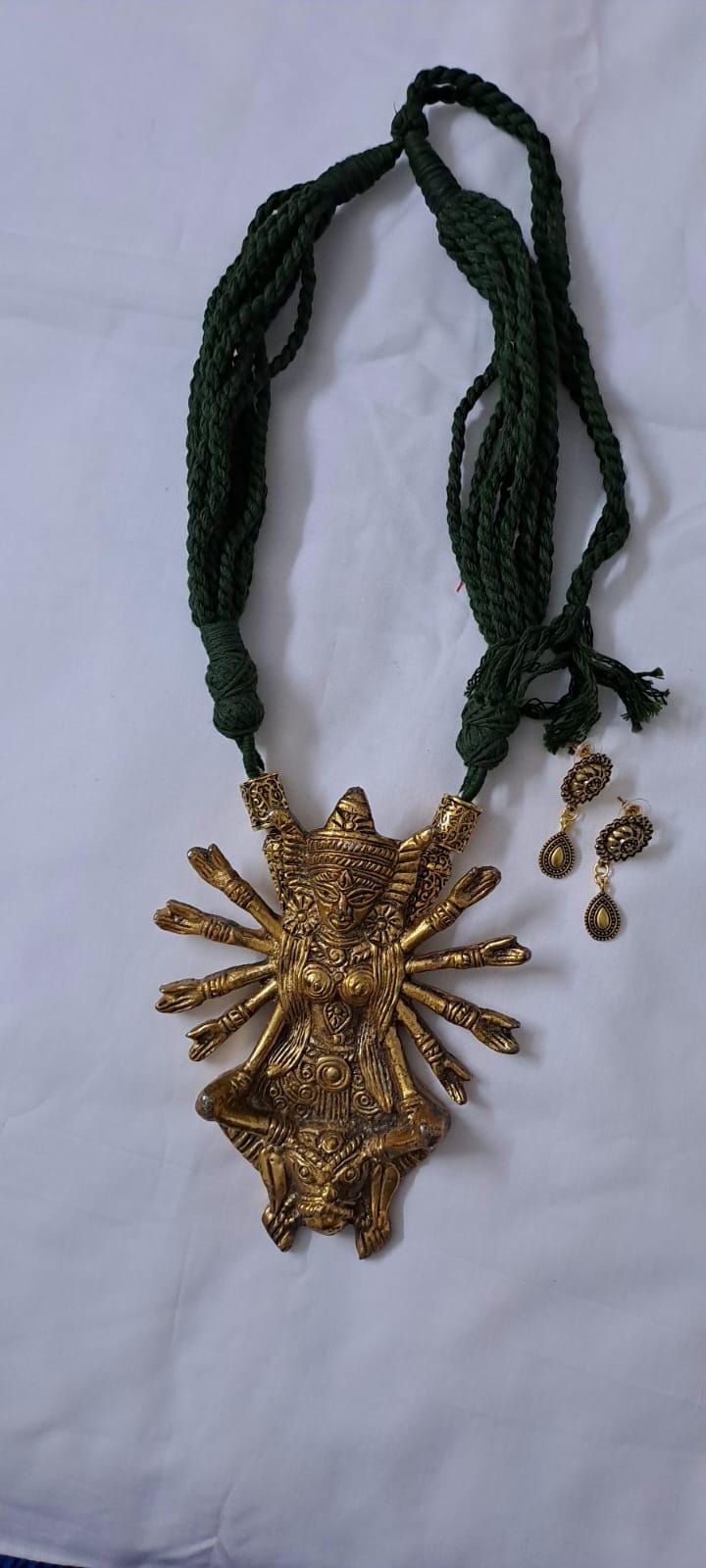 Green thread necklace with oxidised golden durga pendant