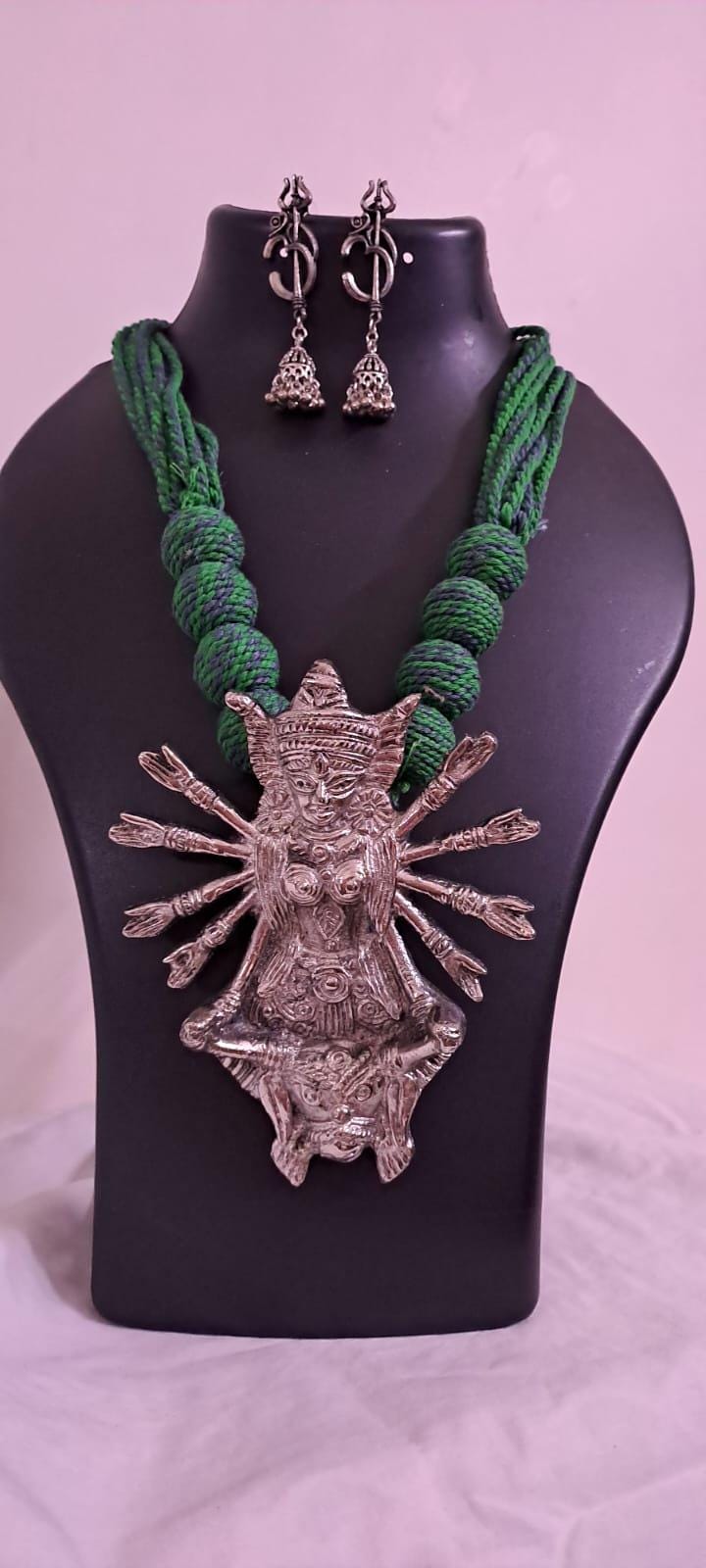 Green thread necklace with oxidised golden durga pendant