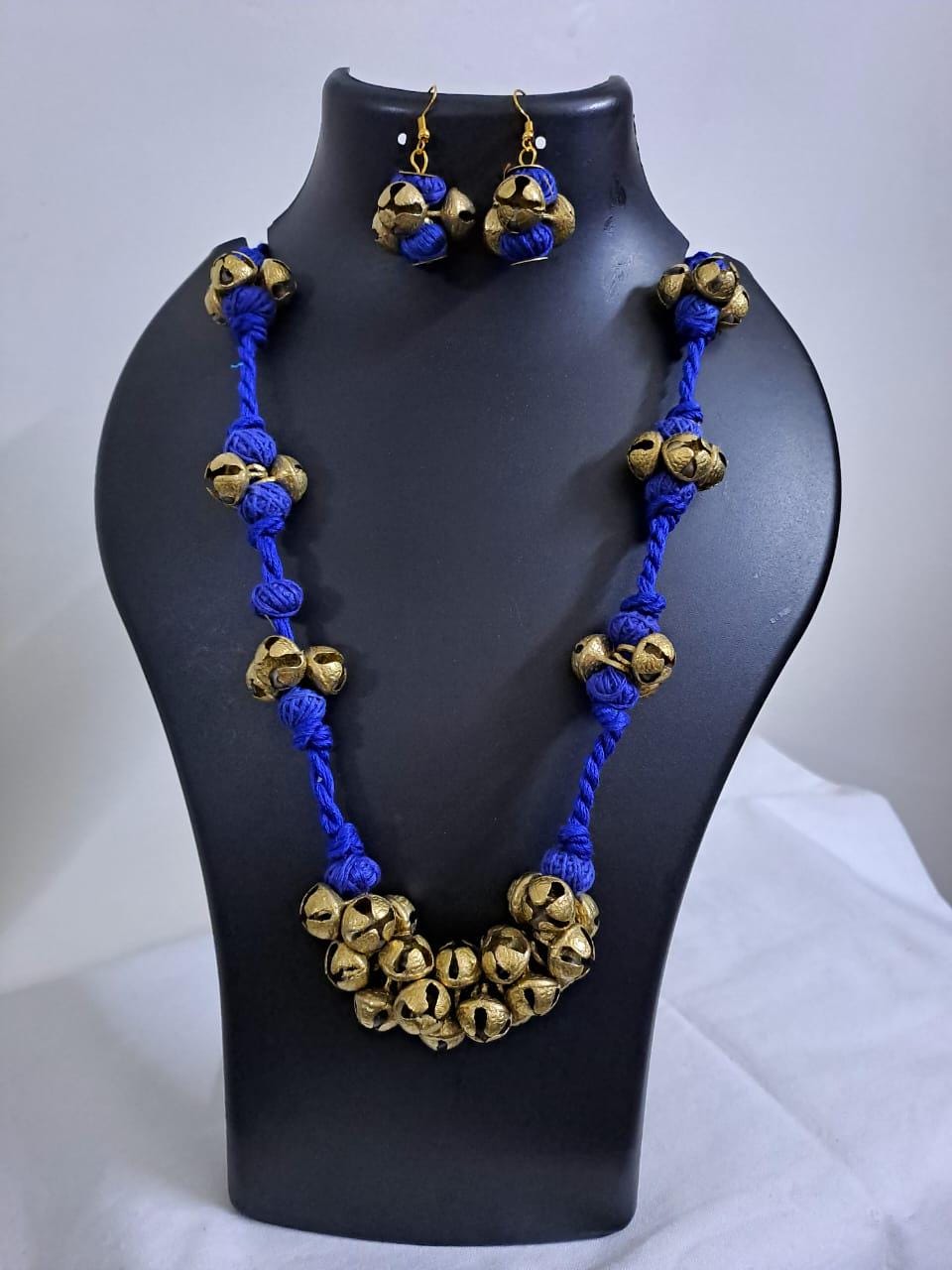 Blue thread necklace with trinkets n matching earrings