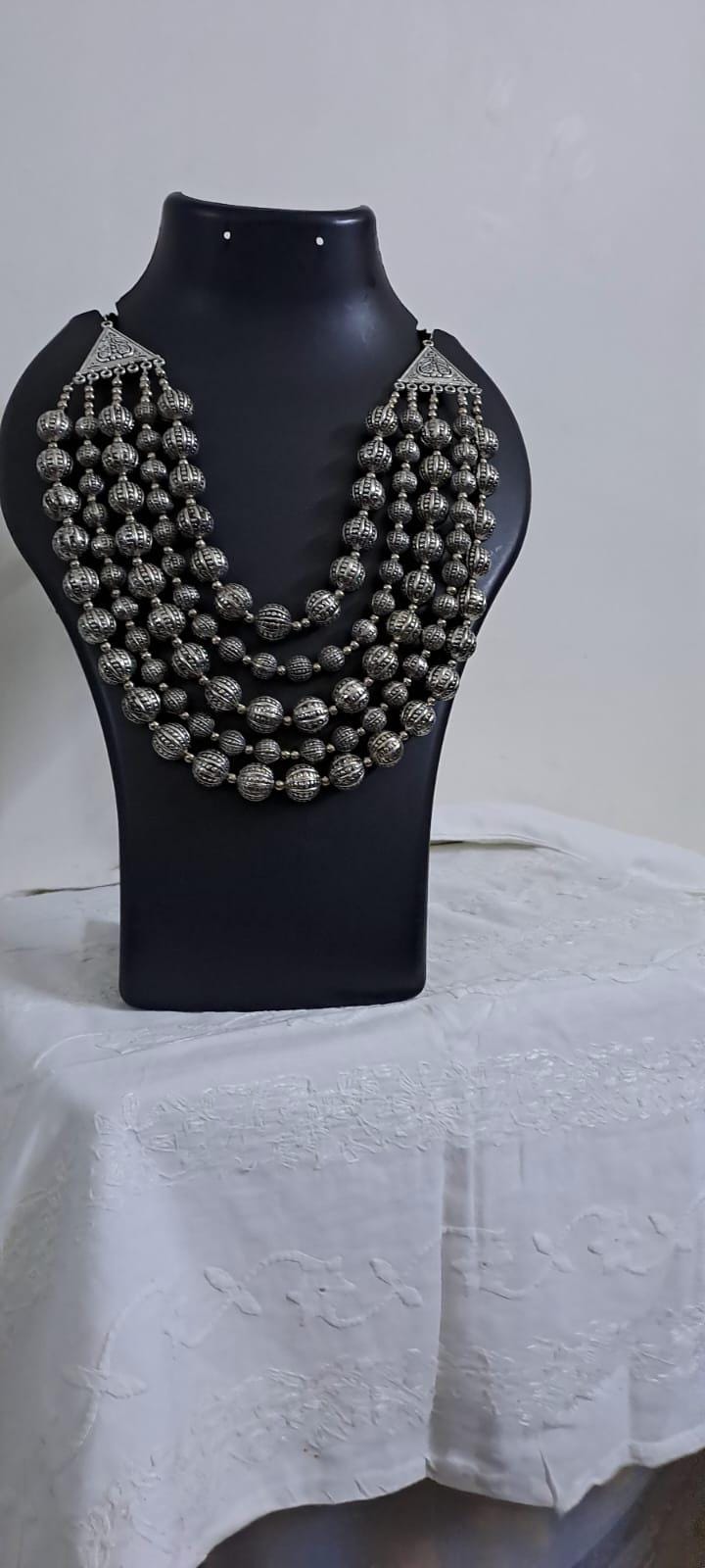 Multi-layered silver oxidised beads necklace .