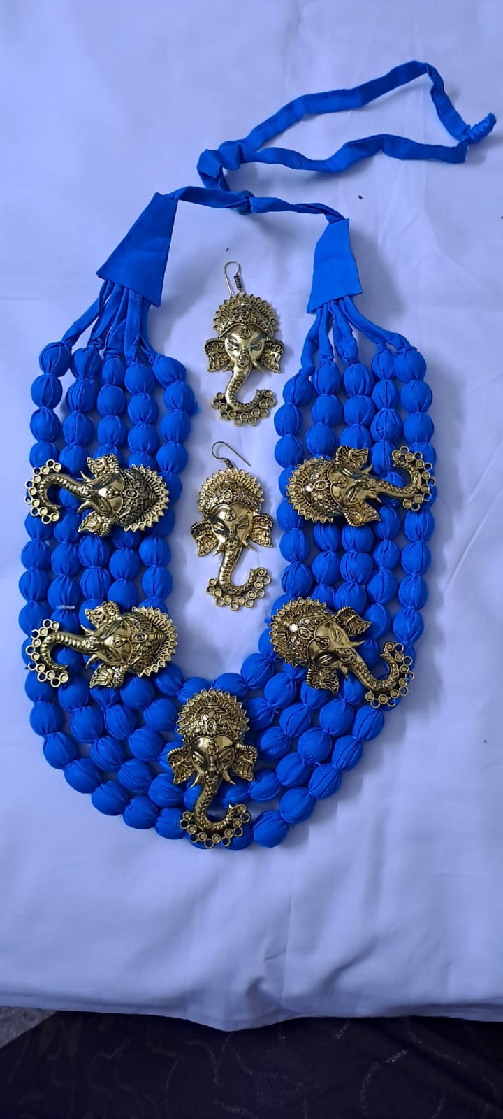 Multilayered fabric beads set with golden oxidised goddess Durga pendants - Blue