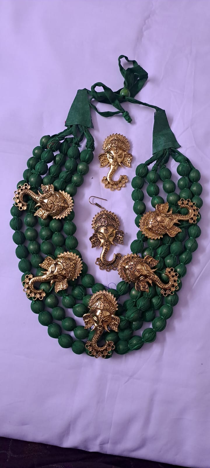 Multilayered fabric beads set with golden oxidised goddess Durga pendants - Dark Green