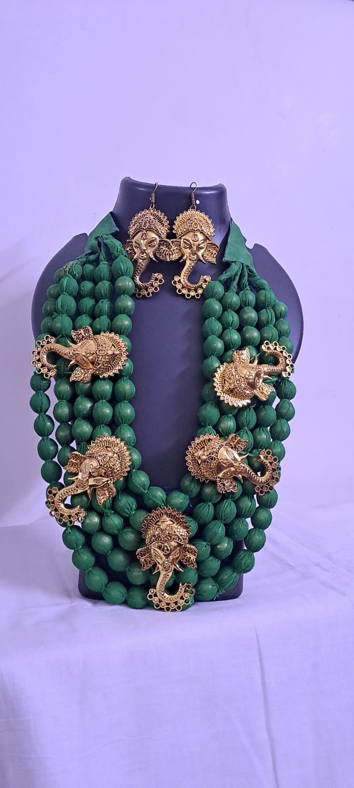 Multilayered fabric beads set with golden oxidised goddess Durga pendants - Dark Green