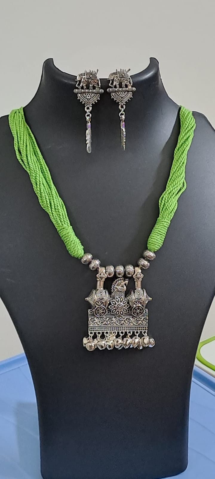 Light green thread necklace with silver oxidised traditional pendant