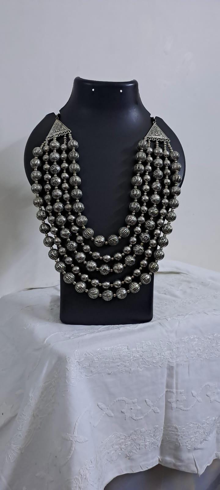 Multi-layered silver oxidised beads necklace .
