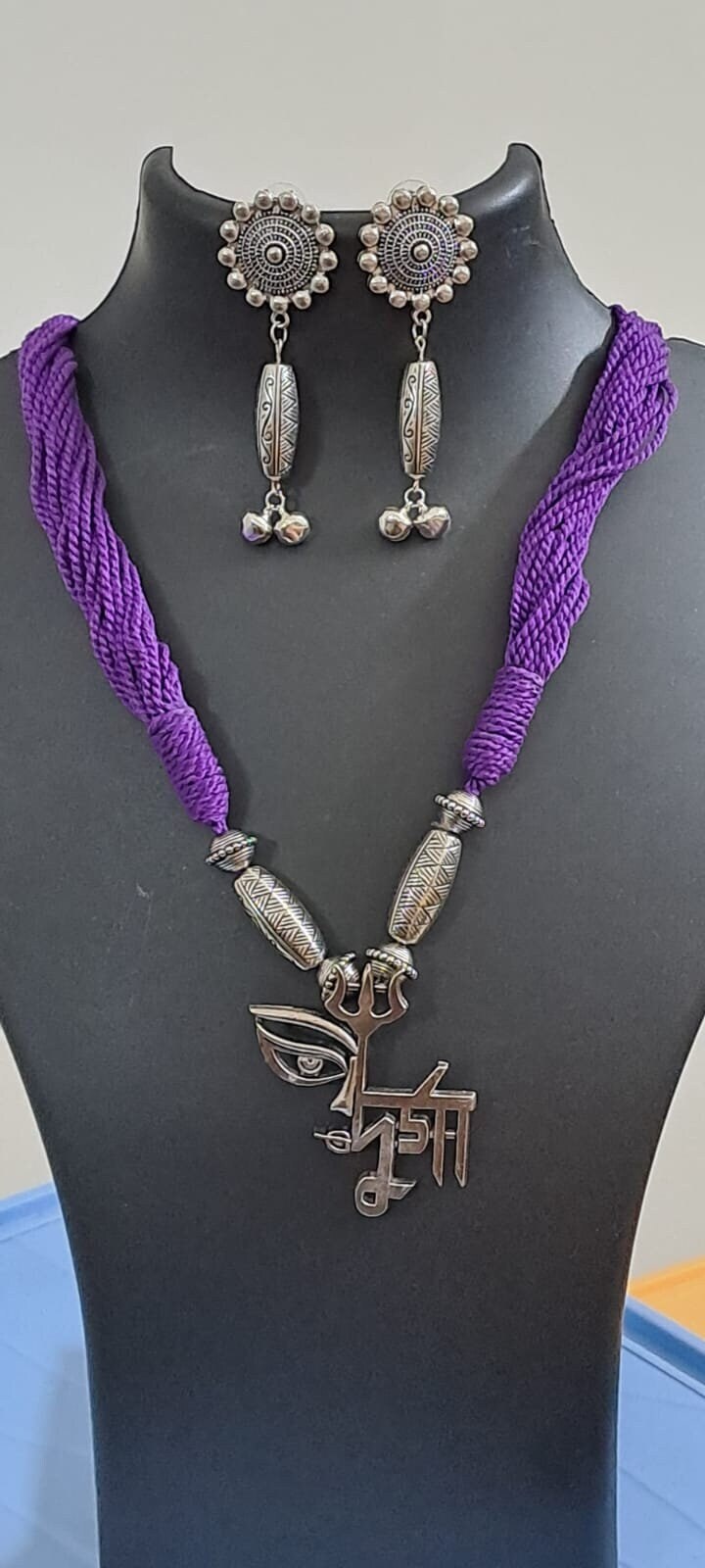 Purple thread necklace with oxidised silver durga pendant