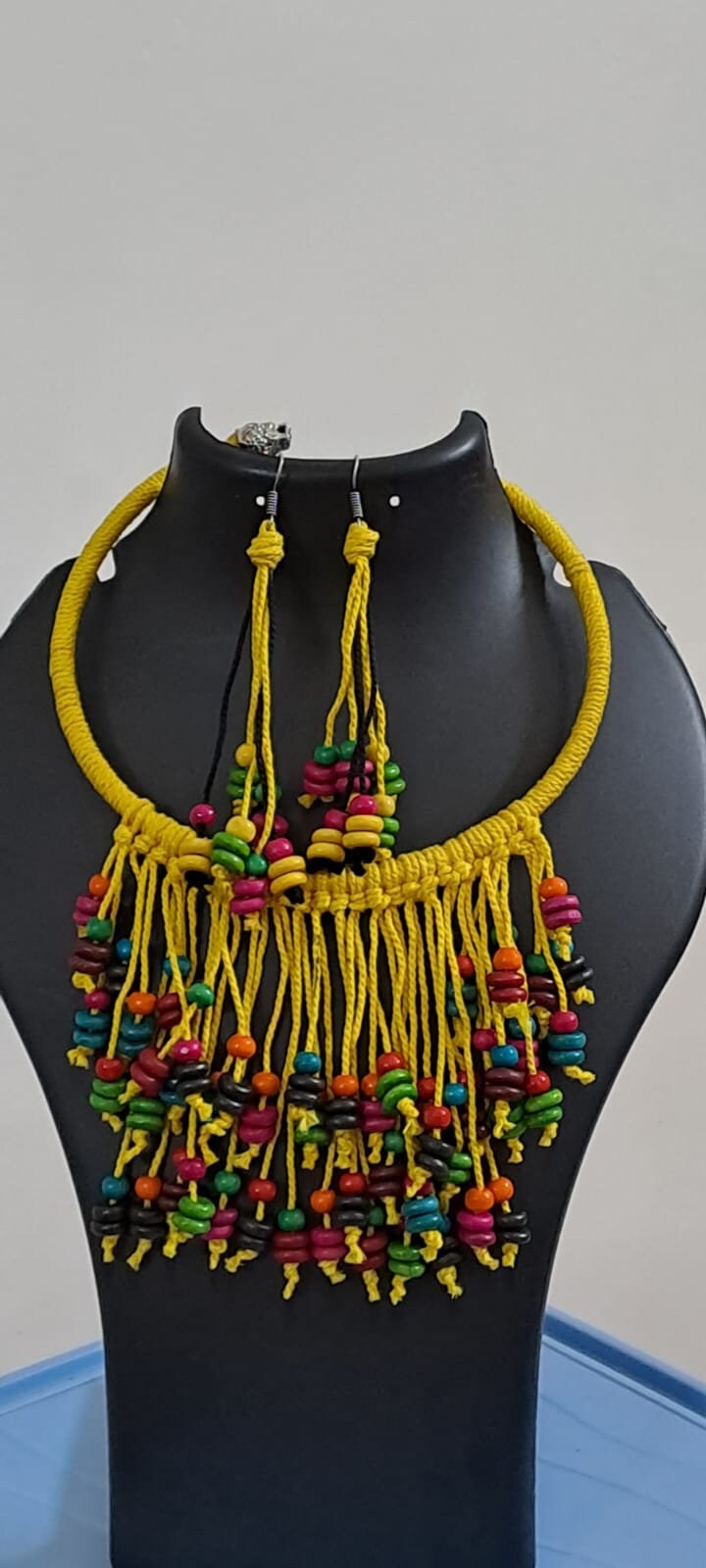 Exclusive yellow thread neckband with fringes and matching earrings.