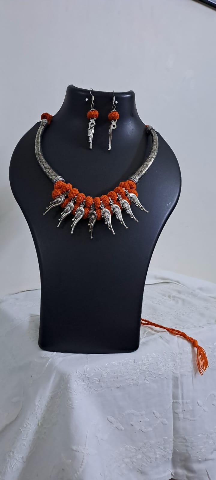 Orange thread necklace with kolhapuri silver oxidised traditional beads and matching earrings