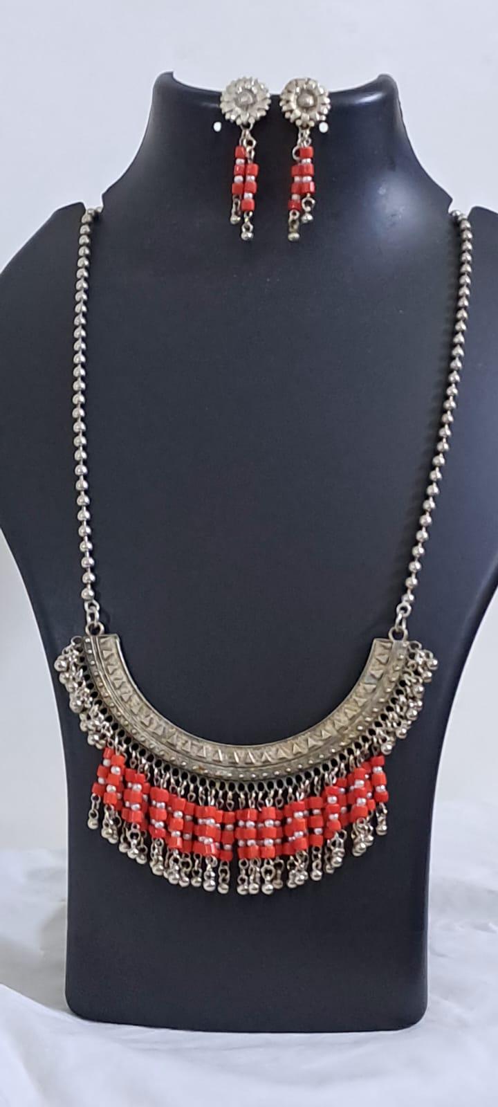 Exclusive necklace with silver oxidised big oval pendant with glass beads fringes and matching earrings.