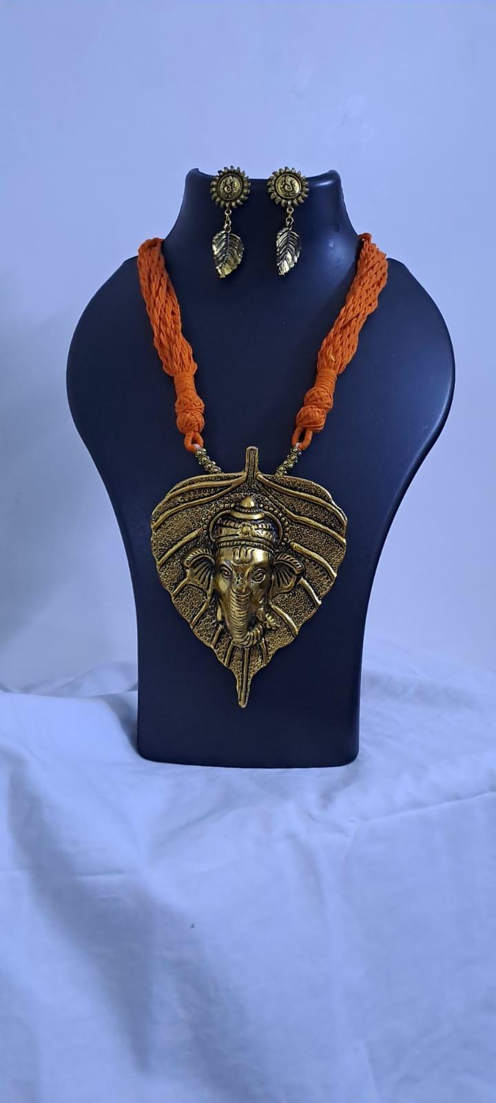 Orange thread necklace with golden oxidised ganesha pendant