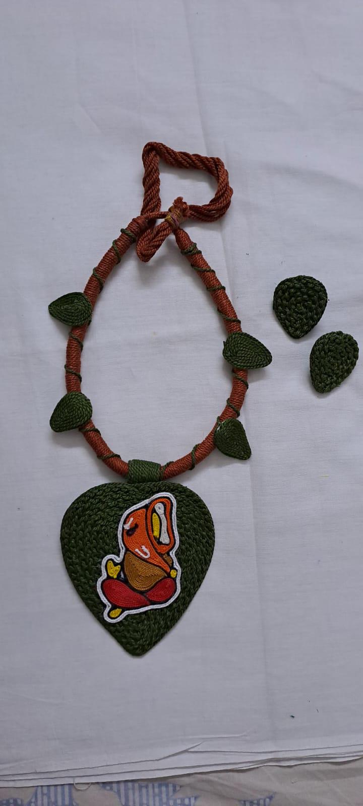 Exclusive forest green and brown thread necklace with leaf shaped  Ganesha thread pendant and matching earrings.