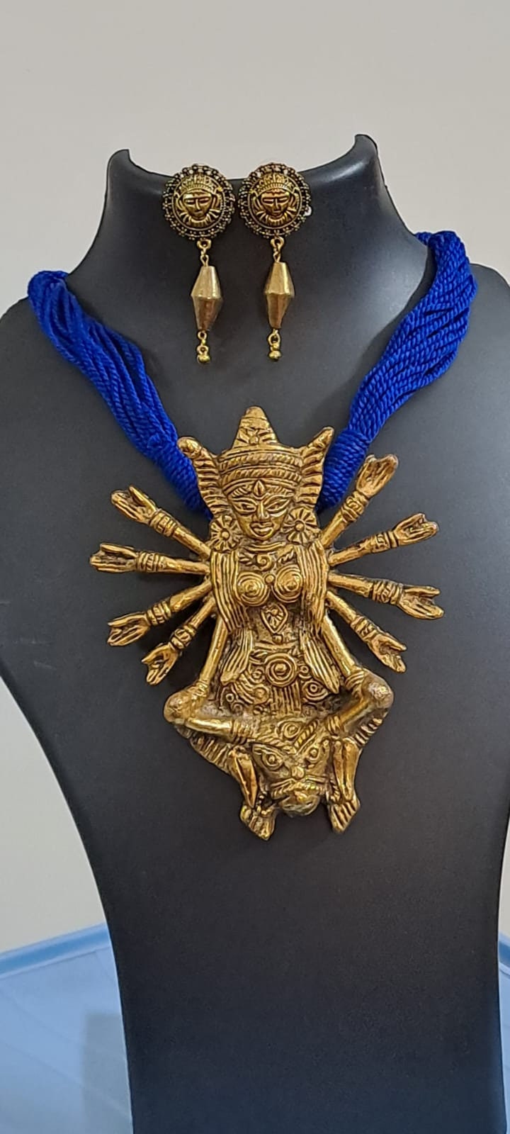 Blue thread necklace with oxidised golden durga pendant