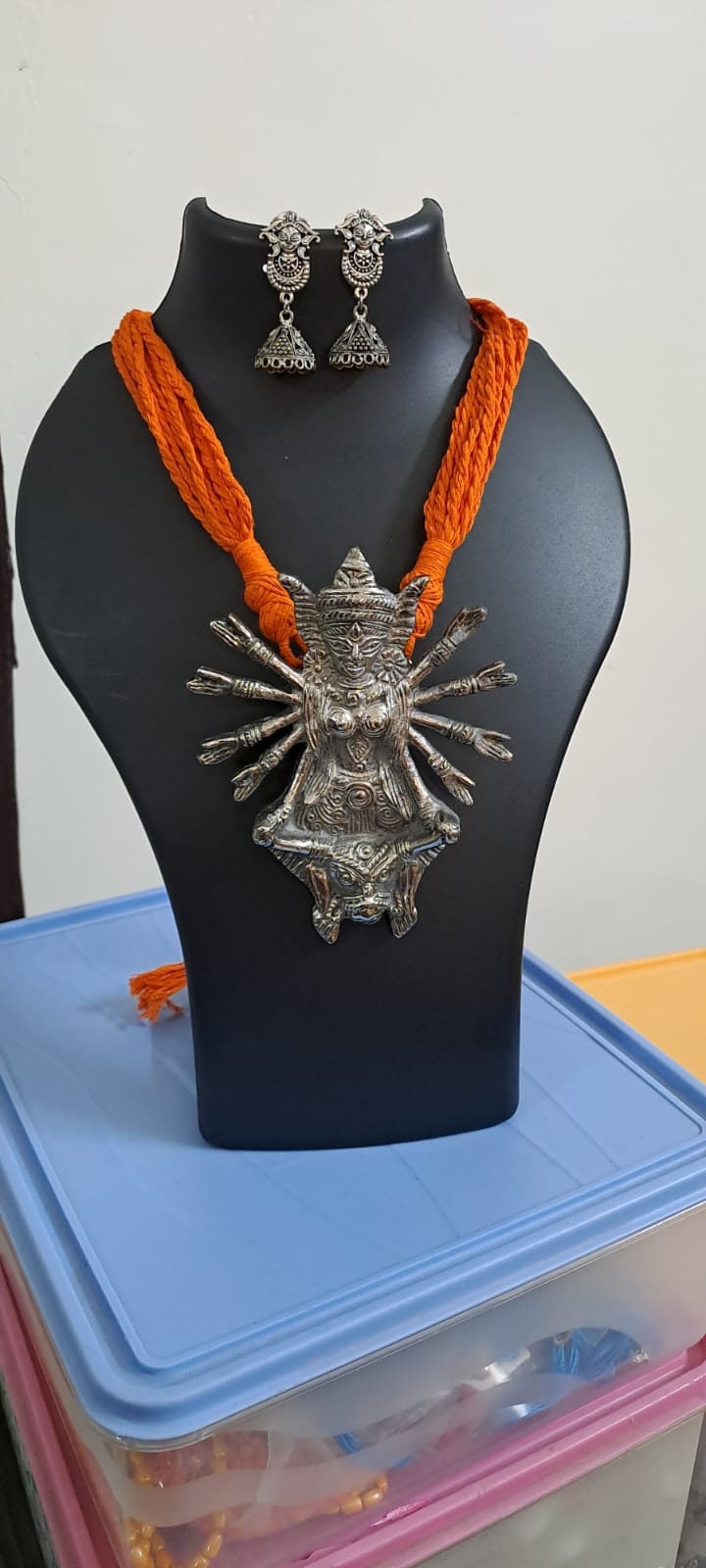 Orange thread necklace with oxidised silver durga pendant