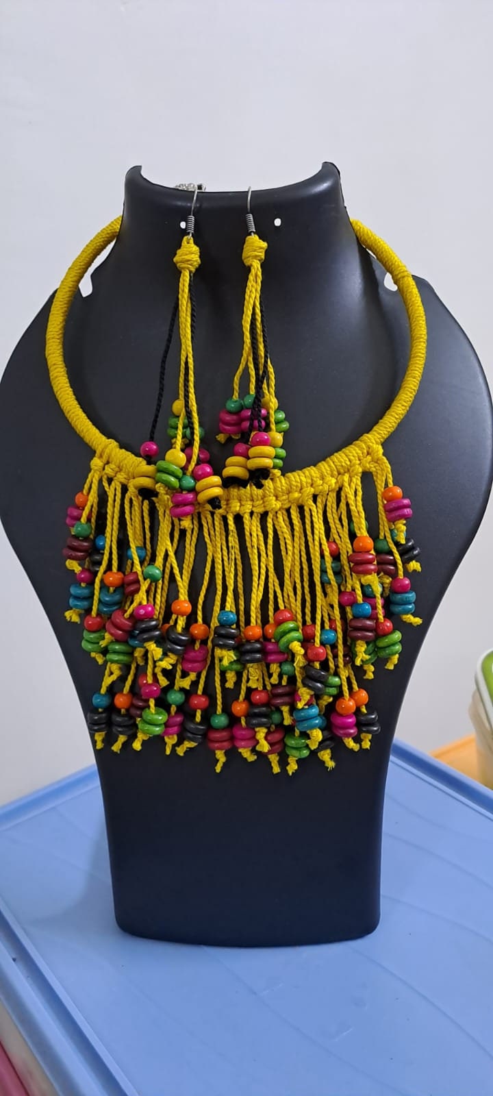 Exclusive yellow thread neckband with fringes and matching earrings.