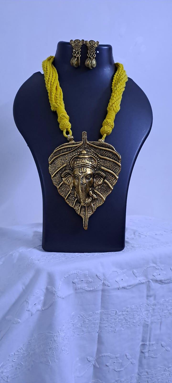 Yellow thread necklace with golden oxidised ganesha pendant