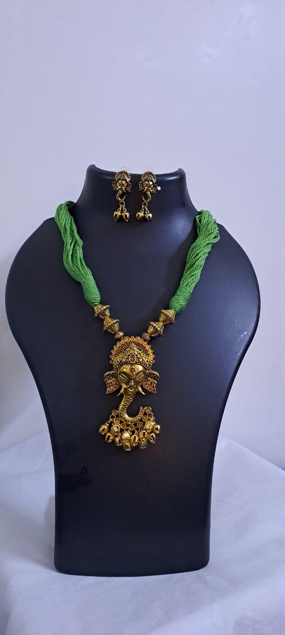Green thread necklace with Golden oxidised traditional pendant