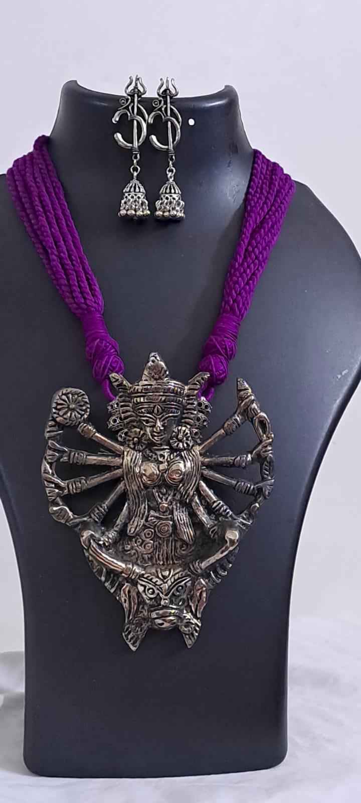 purple thread necklace with oxidised golden durga pendant
