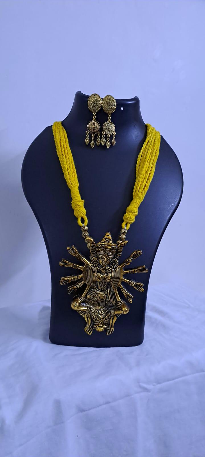 Yellow thread necklace with oxidised golden durga pendant
