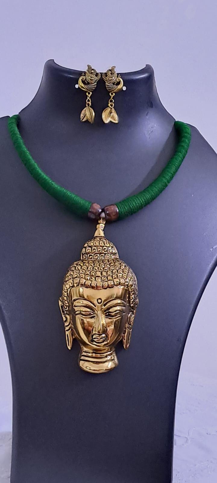 Green thread necklace with oxidised golden buddha pendant