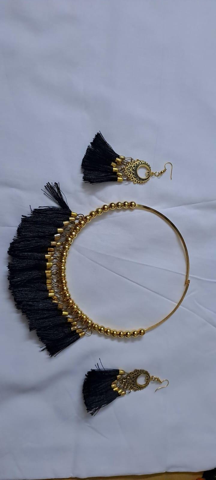 Golden neckband with black silk thread fringes and matching earrings