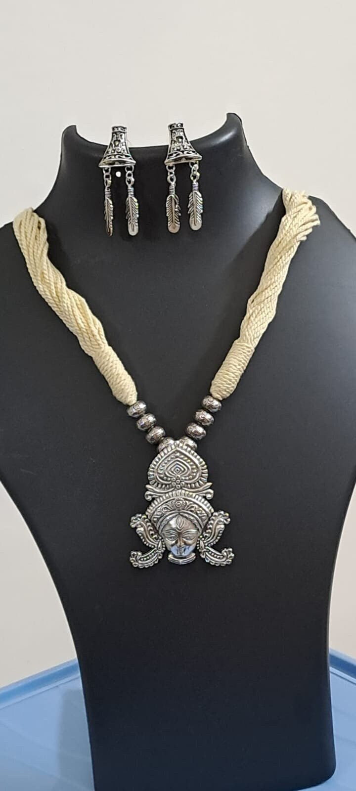 Off white thread necklace with oxidised silver durga pendant