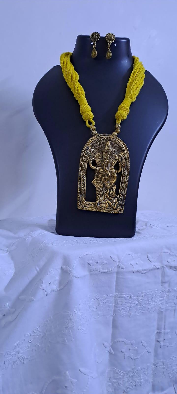 Yellow thread necklace with golden oxidised ganesha pendant
