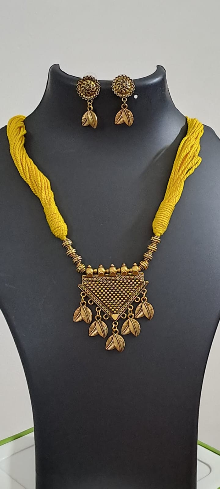 Yellow thread necklace with golden oxidised traditional pendant