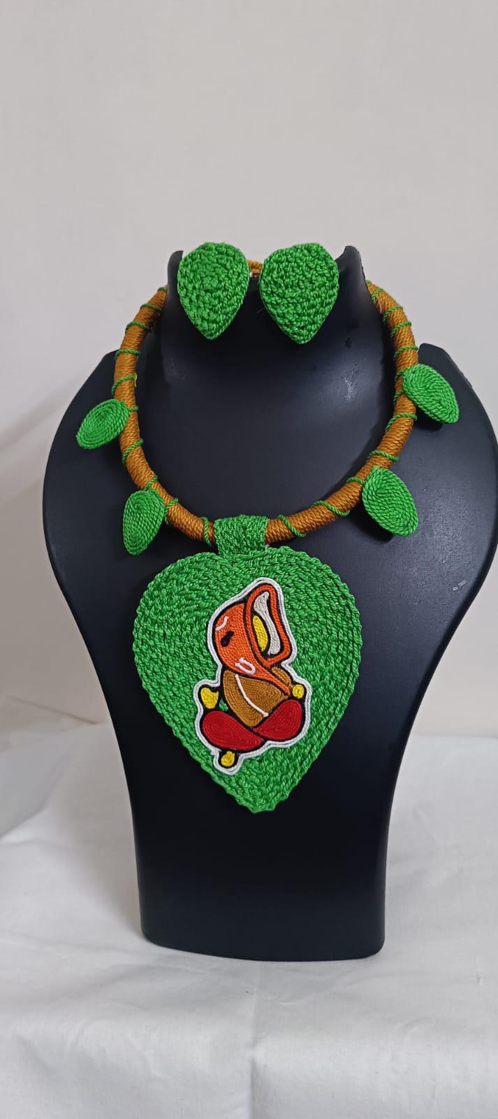 Exclusive light green and brown  thread necklace with leaf shaped  Ganesha pendant  and matching earrings.