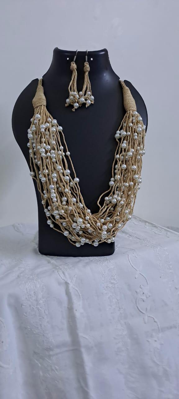 Multi layered jute necklace with pearl beads and with matching earrings.