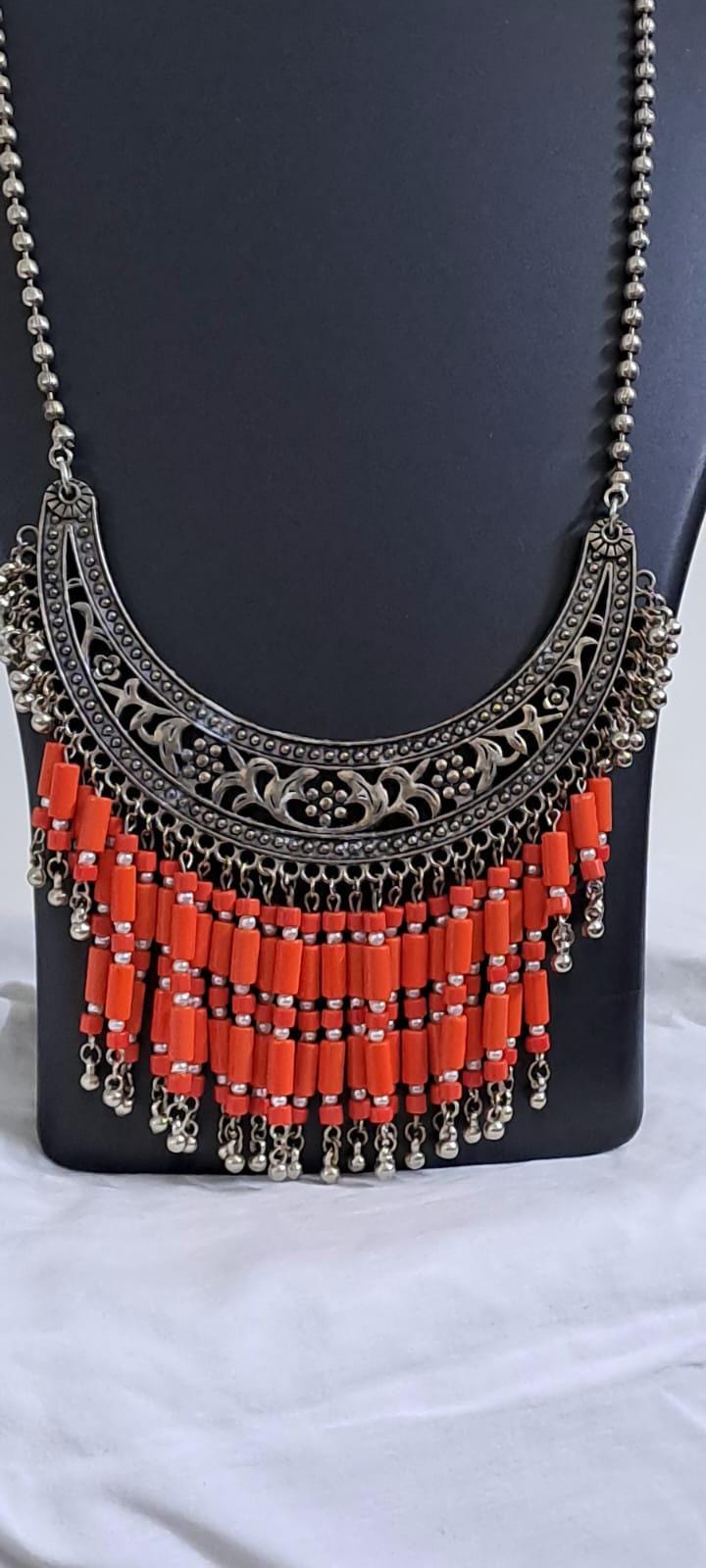Exclusive necklace with silver oxidised big oval pendant with glass beads fringes and matching earrings.