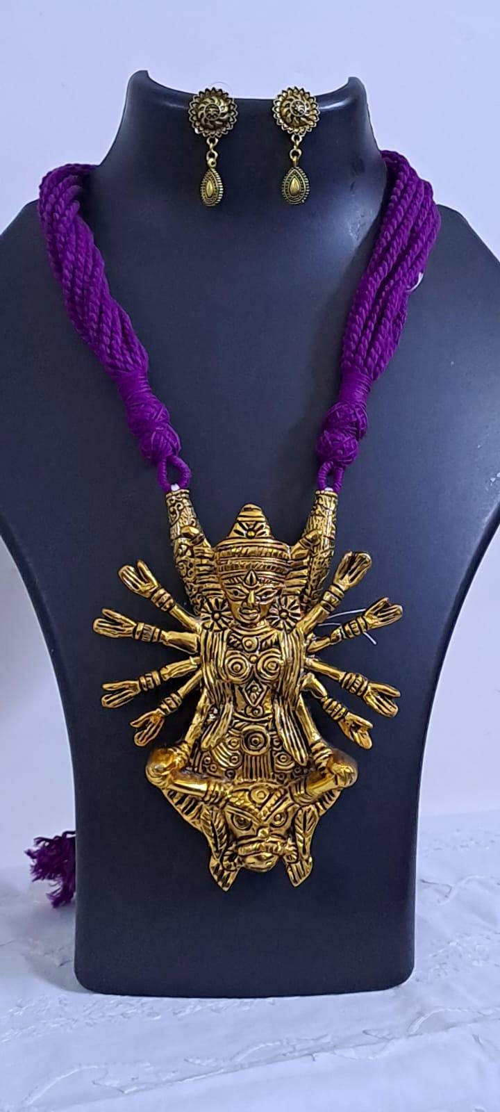 Purple thread necklace with oxidised golden durga pendant
