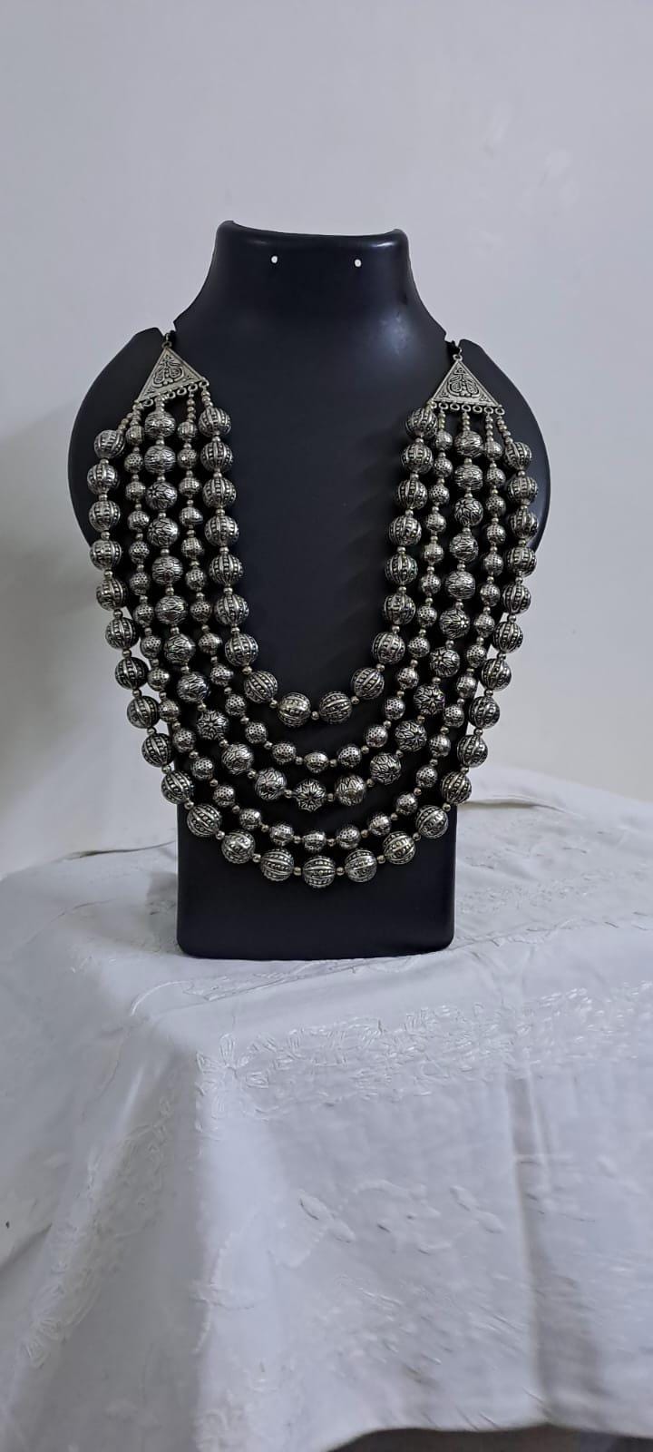 Multi-layered silver oxidised beads necklace .