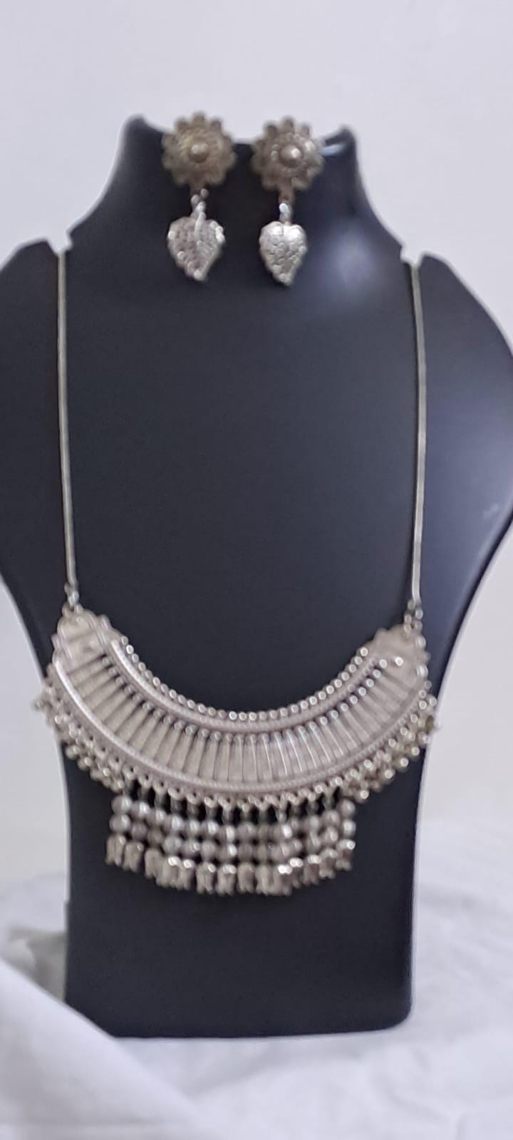 Exclusive necklace with silver oxidised big oval pendant with beads fringes and matching earrings.