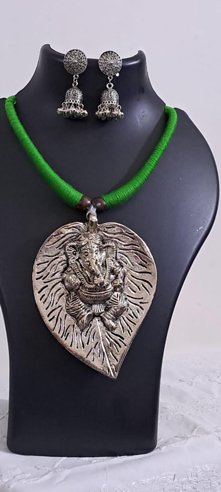 Green thread necklace with silver oxidised ganesha pendant