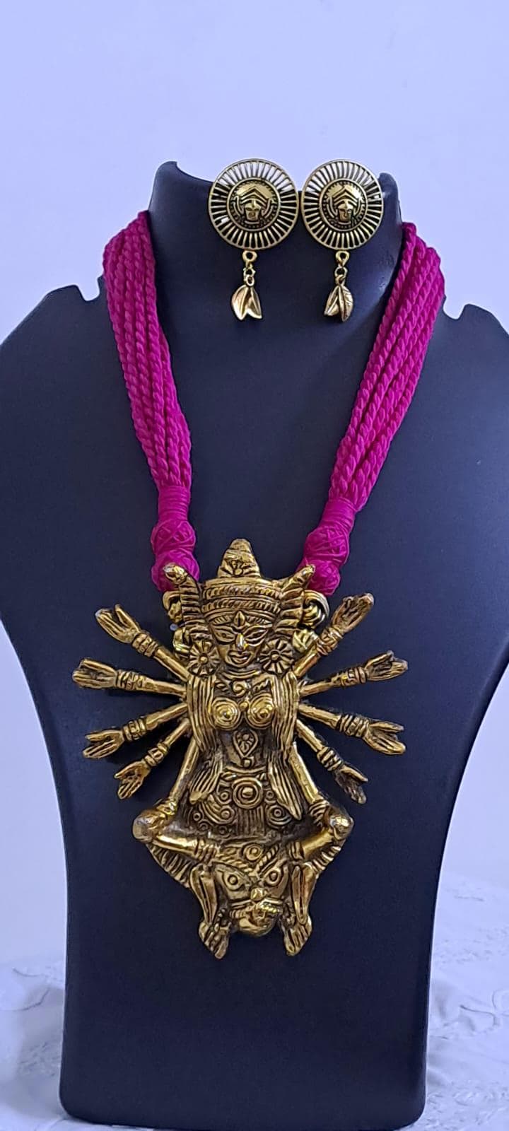Pink thread necklace with oxidised golden durga pendant