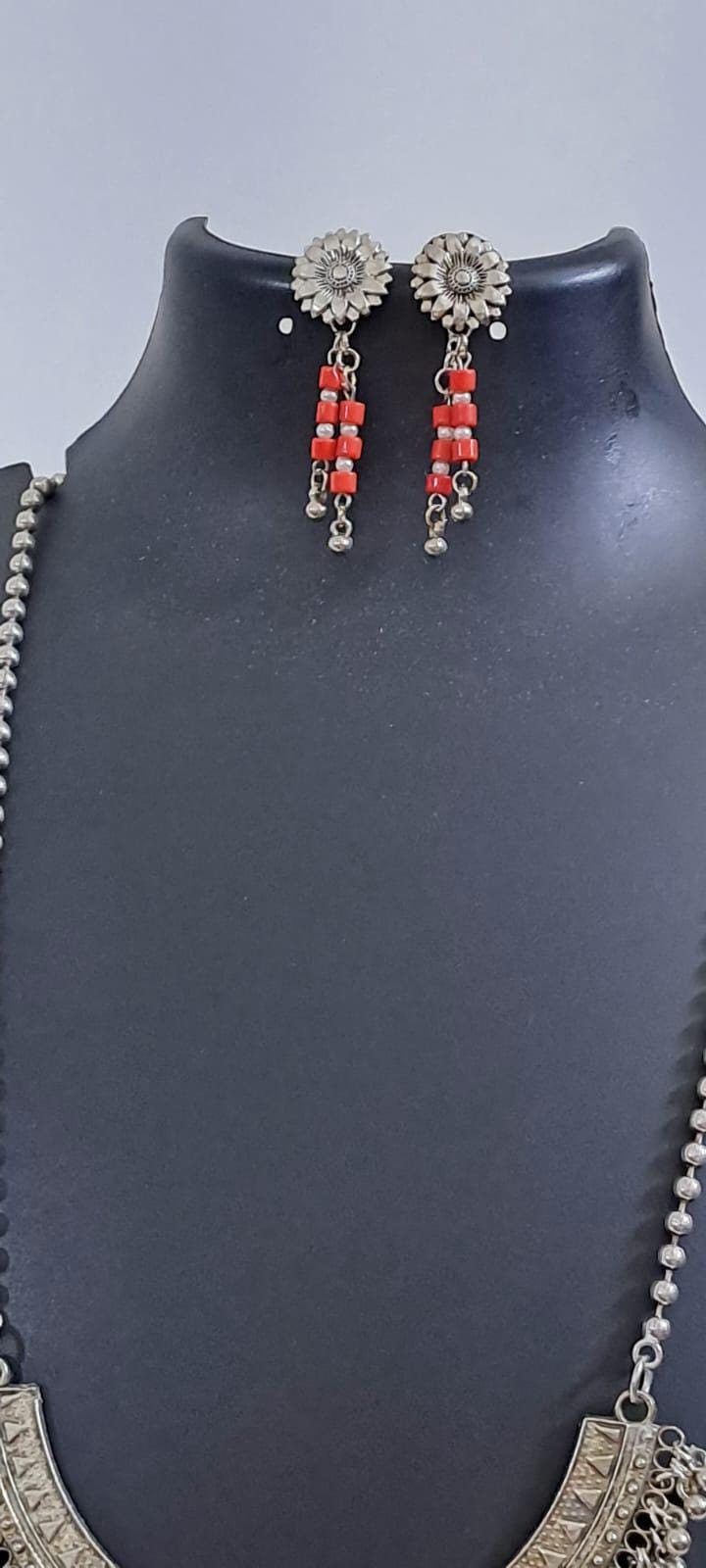 Exclusive necklace with silver oxidised big oval pendant with glass beads fringes and matching earrings.