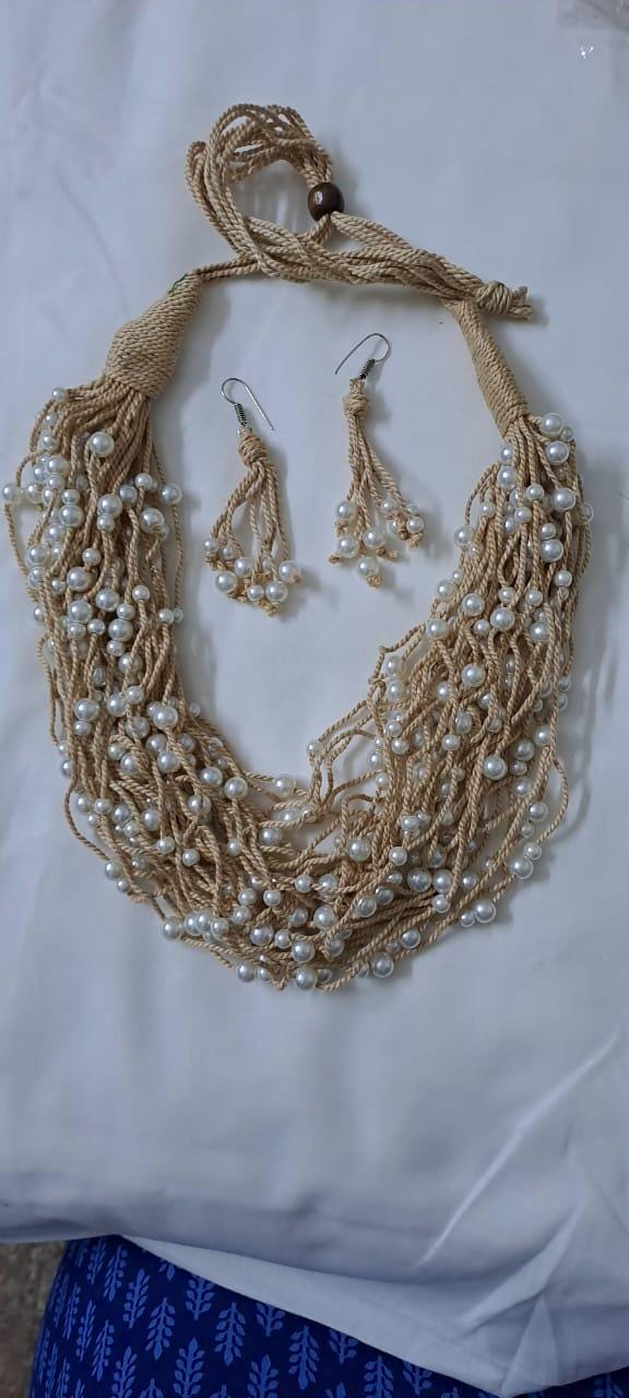 Multi layered jute necklace with pearl beads and with matching earrings.